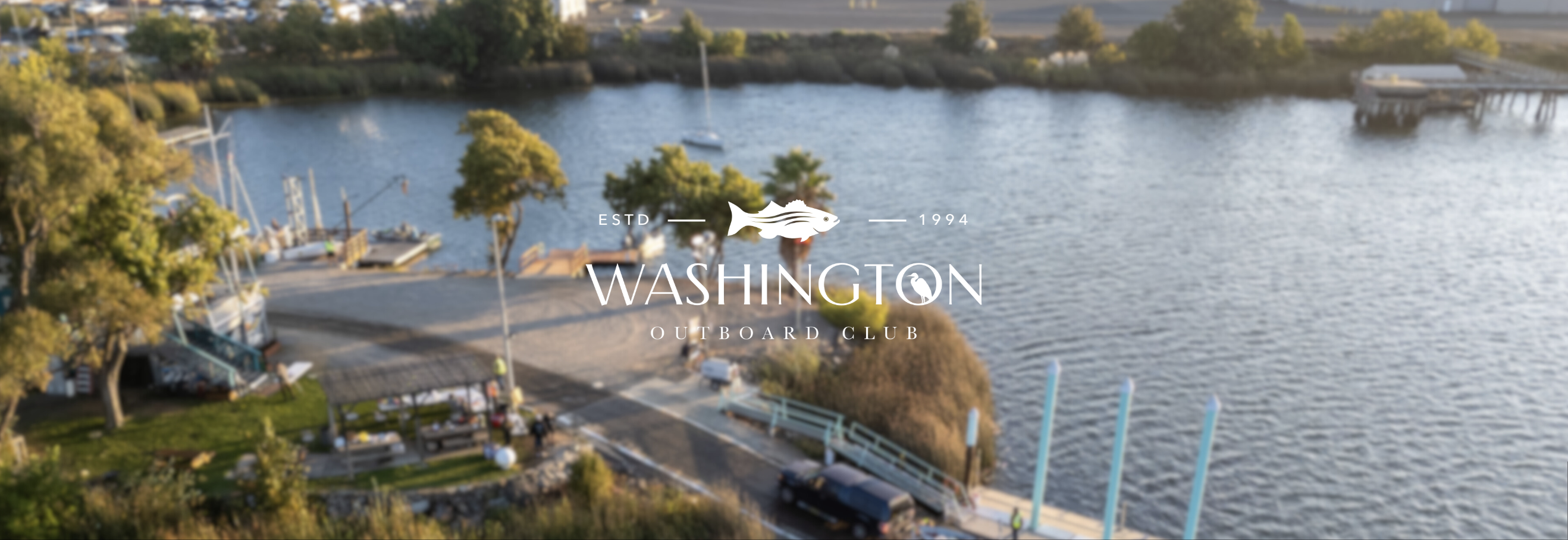 Aerial view of the Washington Outboard Club marina with the Washington Outboard Club wordmark